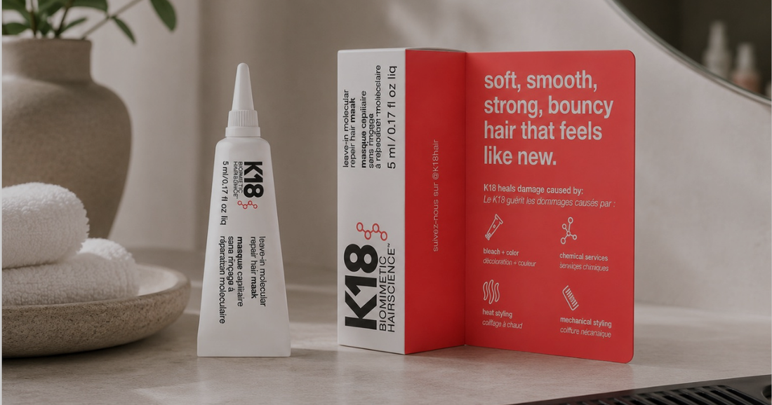 K18 leave-in molecular repair hair mask displayed in a modern hair salon setting with towels and a comb.